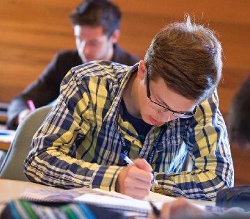 boy writing in class