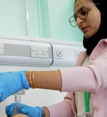 Teacher using a dummy to demonstrate medicine at the cambridge summer school